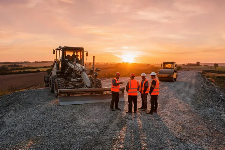 Motor grader mentoring crew on rural road