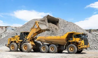 Wheel loader loading aggregate into haul truck